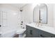 Modern bathroom with gray vanity, white countertop, stylish mirror, and tub-shower combination at 1957 Deloy Dr, Daytona Beach, FL 32119