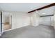 Spacious bedroom featuring neutral carpet, beamed ceiling, and large closet for ample storage at 1957 Deloy Dr, Daytona Beach, FL 32119