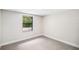 Bedroom features neutral carpet and a large window with a nature view at 1957 Deloy Dr, Daytona Beach, FL 32119