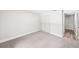 Bedroom with neutral carpet, closet and access to hallway at 1957 Deloy Dr, Daytona Beach, FL 32119