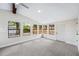 Sunlit bedroom with multiple windows, neutral carpet and a door providing access to the outdoors at 1957 Deloy Dr, Daytona Beach, FL 32119