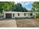 Charming single-story home with a freshly painted facade, attached garage, and simple landscaping at 1957 Deloy Dr, Daytona Beach, FL 32119