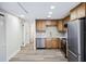 Updated kitchen featuring stainless steel appliances, wood cabinets, quartz counters, and modern flooring at 1957 Deloy Dr, Daytona Beach, FL 32119