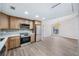 Open kitchen with stainless steel appliances, wood cabinets, quartz counters, and modern flooring at 1957 Deloy Dr, Daytona Beach, FL 32119