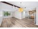 Bright living room features vaulted ceilings, an eye catching light fixture, and updated flooring at 1957 Deloy Dr, Daytona Beach, FL 32119