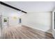 Bright living room features vaulted ceilings, an eye catching light fixture, and updated flooring at 1957 Deloy Dr, Daytona Beach, FL 32119