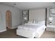 Bright bedroom featuring a padded headboard, white bedding, and neutral decor at 2381 Courtland Blvd, Deltona, FL 32738