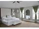 Stylish bedroom with upholstered headboard, tufted ottoman, and arched wall mirror at 2381 Courtland Blvd, Deltona, FL 32738