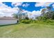 Spacious backyard with lush green grass and privacy landscaping, offering a serene outdoor retreat at 2498 Iris Rd, Deland, FL 32724