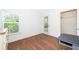 Bright bedroom with wood floors features a window, closet, and private outdoor access at 2498 Iris Rd, Deland, FL 32724