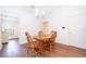 Dining room with natural lighting, chandelier and wood table with 4 chairs at 2498 Iris Rd, Deland, FL 32724