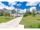 Charming single-story home with a well-manicured lawn, a long driveway, and an attached garage at 2498 Iris Rd, Deland, FL 32724