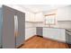 Bright kitchen featuring white cabinets, stainless steel appliances and granite countertops at 2498 Iris Rd, Deland, FL 32724