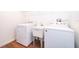 Laundry room with washer, dryer and utility sink on wood floor at 2498 Iris Rd, Deland, FL 32724