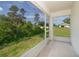 Enclosed patio area with screens, offering an outdoor view of the surrounding trees and the neighborhood at 2498 Iris Rd, Deland, FL 32724