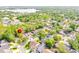 Aerial view of a residential neighborhood with lush greenery and a lake nearby at 254 Oak Park Pl, Casselberry, FL 32707