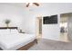 Comfortable bedroom featuring a ceiling fan, a mounted television, and a doorway leading to an ensuite bathroom at 254 Oak Park Pl, Casselberry, FL 32707