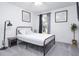 Cozy bedroom with a metal frame bed, soft gray carpet, and natural light from the window at 254 Oak Park Pl, Casselberry, FL 32707