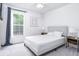 Bright bedroom features a large window, plush carpet, and neutral decor for a serene atmosphere at 254 Oak Park Pl, Casselberry, FL 32707