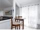 Breakfast nook with a round wooden table, three chairs, and a large window with sheer white curtains at 254 Oak Park Pl, Casselberry, FL 32707