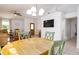 Cozy dining room with wood table and chairs, adjacent to living room with a ceiling fan and modern finishes at 254 Oak Park Pl, Casselberry, FL 32707
