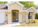 Close-up showcasing a beautifully designed front entrance, wood door, and decorative accents creating curb appeal at 254 Oak Park Pl, Casselberry, FL 32707
