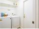 Well-equipped laundry room with a modern washer and dryer, overhead storage, and a doorway at 254 Oak Park Pl, Casselberry, FL 32707