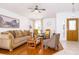 Inviting living room with hardwood floors, neutral decor, and a decorative front door at 254 Oak Park Pl, Casselberry, FL 32707