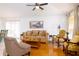 Bright living room with wood floors, comfortable seating, and large windows providing natural light at 254 Oak Park Pl, Casselberry, FL 32707