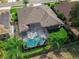 Aerial view of the backyard of a home with a screened in pool and tropical landscaping at 2643 University Acres Dr, Orlando, FL 32817