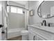 Cozy bathroom with modern vanity, white fixtures, framed mirror and a shower-tub combination with curtain at 2643 University Acres Dr, Orlando, FL 32817