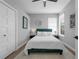 Cozy bedroom featuring an emerald green headboard, accent pillows, and soft rug, creating a relaxing retreat at 2643 University Acres Dr, Orlando, FL 32817