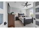 Stylish bedroom with a dark wood bed frame, neutral walls, decorative lamps, and natural light from the window at 2643 University Acres Dr, Orlando, FL 32817