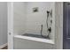Convenient dog wash area with tiled walls, handheld shower, and a comfortable platform for easy grooming at 2643 University Acres Dr, Orlando, FL 32817