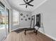 Bright home gym with exercise machine, mirror, and view to outside at 2643 University Acres Dr, Orlando, FL 32817