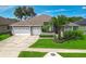 Charming single-story home featuring a manicured front lawn and a spacious two-car garage at 2643 University Acres Dr, Orlando, FL 32817