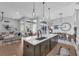 Stylish kitchen featuring a large island, pendant lighting, and open access to the dining and living areas at 2643 University Acres Dr, Orlando, FL 32817