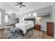 Serene main bedroom featuring a tray ceiling, neutral décor, and large windows for natural light at 2643 University Acres Dr, Orlando, FL 32817