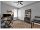 Functional home office with dual monitors, ample desk space, storage shelves, and a comfortable work environment at 2643 University Acres Dr, Orlando, FL 32817