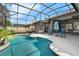 In-ground swimming pool with surrounding patio, pool screen, and an outdoor seating area at 2643 University Acres Dr, Orlando, FL 32817
