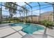 An in-ground backyard pool with beautiful landscaping and a screened enclosure at 2643 University Acres Dr, Orlando, FL 32817
