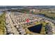 Aerial view of a well-planned neighborhood featuring homes with pond views and community amenities at 2941 Marlberry Ln, Clermont, FL 34714