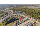 Aerial view of residential neighborhood highlighting the home's location near a pond and green spaces at 2941 Marlberry Ln, Clermont, FL 34714