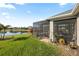 Beautiful backyard with lush green grass, mature landscaping, and a screened lanai overlooking the serene pond at 2941 Marlberry Ln, Clermont, FL 34714