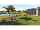 Lush backyard featuring a pond view, well manicured lawn, and screened-in lanai for outdoor relaxation at 2941 Marlberry Ln, Clermont, FL 34714