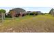 Spacious backyard, complete with a screened lanai, provides ample space for recreation and relaxation at 2941 Marlberry Ln, Clermont, FL 34714