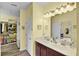 Bright bathroom featuring double vanity, closet and wood-look flooring at 2941 Marlberry Ln, Clermont, FL 34714
