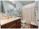 Charming bathroom featuring decorative lace shower curtain and vanity at 2941 Marlberry Ln, Clermont, FL 34714