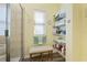 Bathroom with walk-in shower, storage shelf and tiled walls at 2941 Marlberry Ln, Clermont, FL 34714