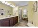 Well-lit bathroom features dual sinks, granite counters, and walk-in glass enclosed shower at 2941 Marlberry Ln, Clermont, FL 34714